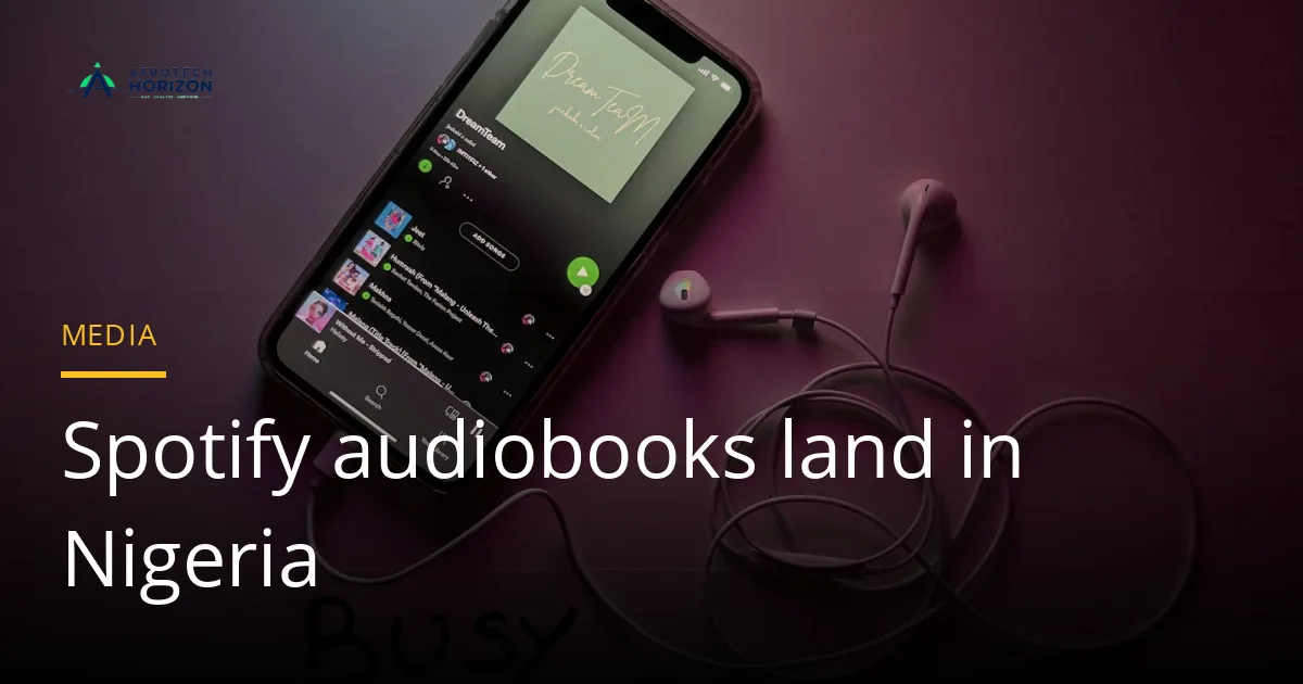 A smartphone with a music streaming app open, lying next to wired earphones